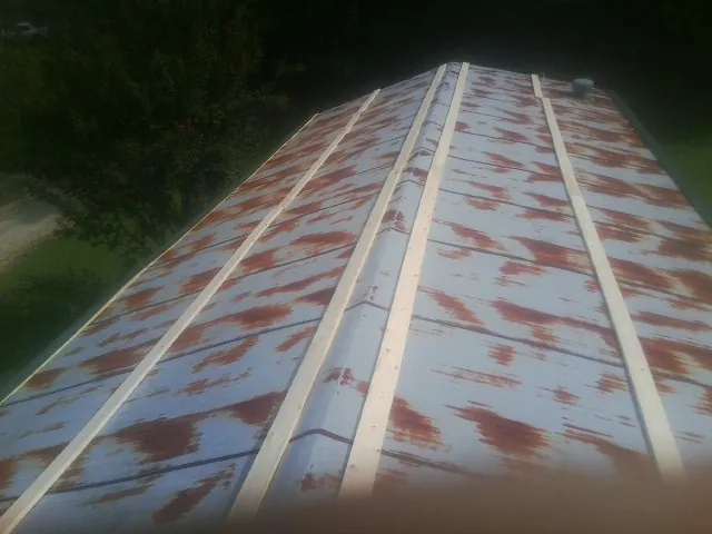 Rusted metal roof panels with new wood purlins before replacement — Storm Damage Roof Repair in Pennington by Roofing Brothers
